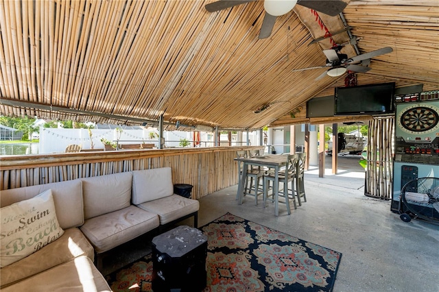 unfurnished living room featuring ceiling fan, lofted ceiling, and wood walls