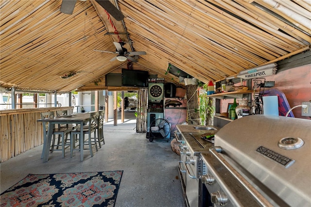 interior space featuring ceiling fan, wood walls, and vaulted ceiling