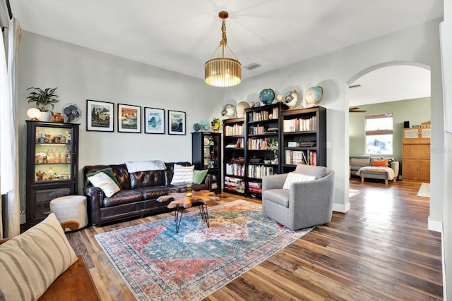 living room with wood-type flooring and a notable chandelier