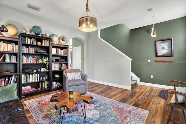 sitting room with dark hardwood / wood-style floors and a notable chandelier