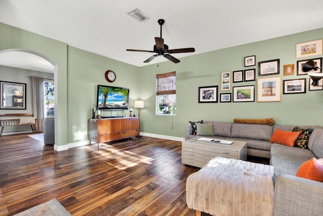 living room featuring ceiling fan and dark hardwood / wood-style flooring