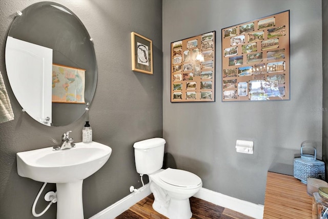 bathroom featuring toilet and hardwood / wood-style flooring