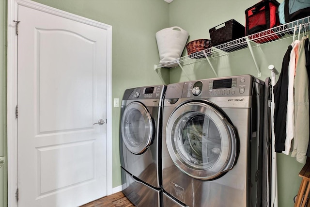 laundry area featuring hardwood / wood-style flooring and separate washer and dryer