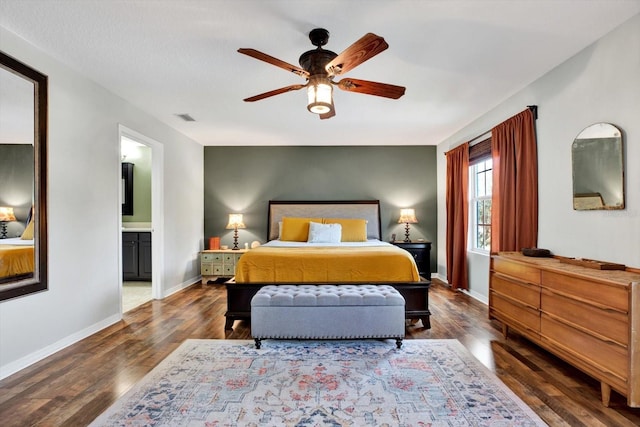 bedroom with dark hardwood / wood-style flooring, ensuite bath, and ceiling fan