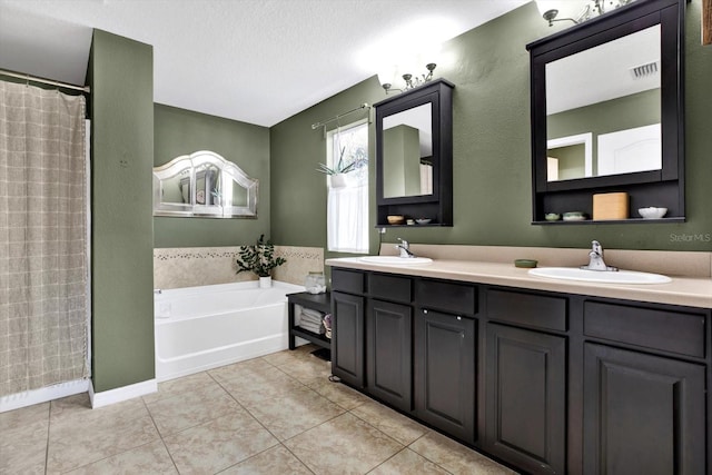 bathroom featuring a textured ceiling, vanity, tile patterned floors, and independent shower and bath