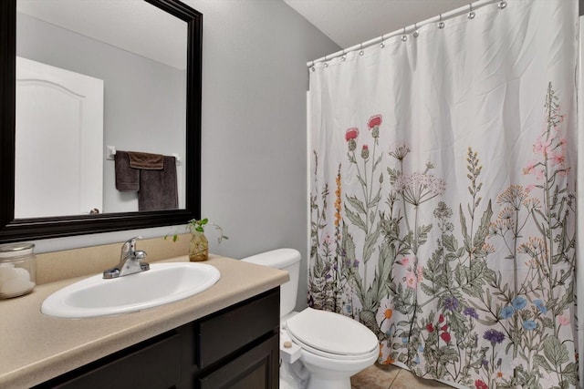 bathroom with tile patterned floors, vanity, and toilet