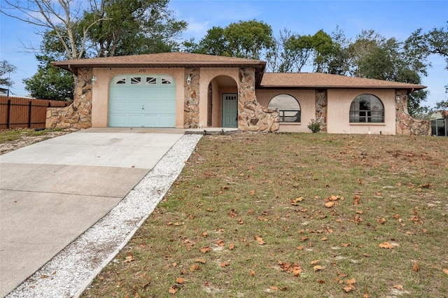 single story home with a garage and a front lawn