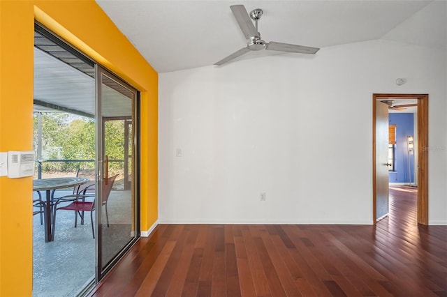 empty room with ceiling fan, dark hardwood / wood-style floors, and lofted ceiling