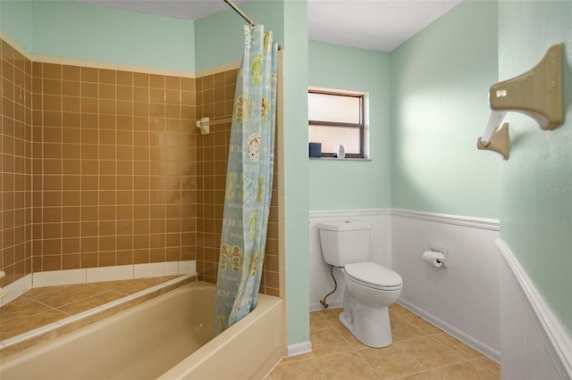 bathroom featuring tile patterned floors, toilet, and shower / bathtub combination with curtain