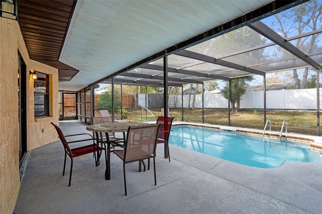 view of pool with a patio and glass enclosure