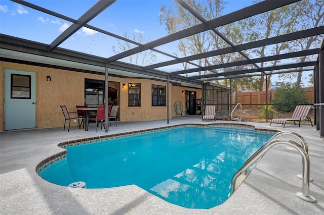 view of swimming pool with glass enclosure and a patio