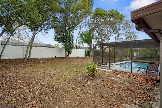 view of yard with a fenced in pool