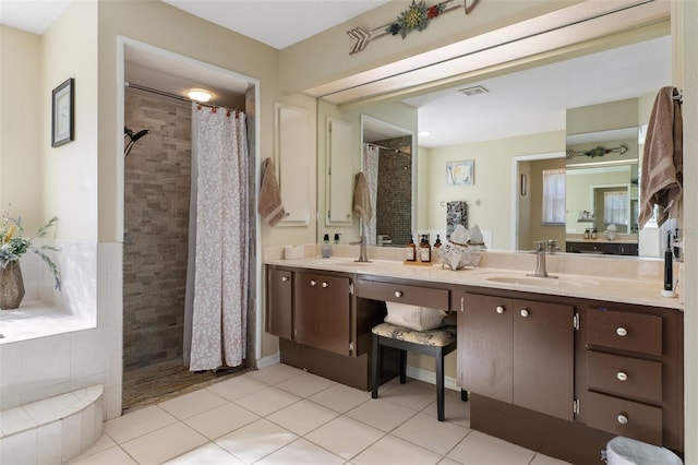 bathroom featuring tile patterned floors, vanity, and walk in shower