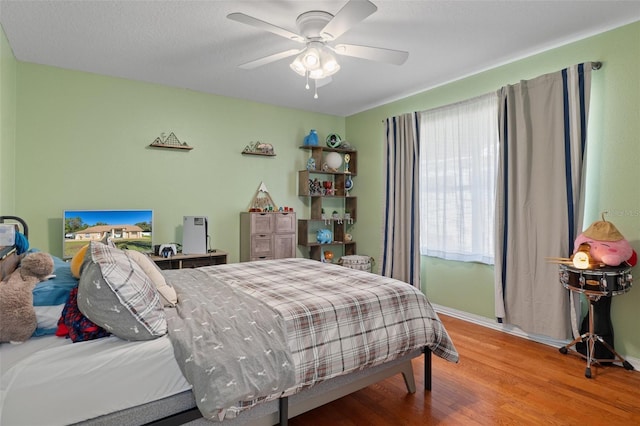 bedroom featuring hardwood / wood-style flooring and ceiling fan