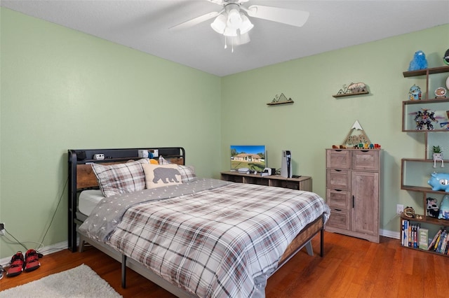 bedroom featuring hardwood / wood-style flooring and ceiling fan