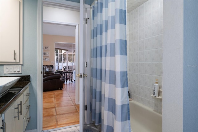 bathroom with tile patterned flooring, vanity, and shower / bathtub combination with curtain