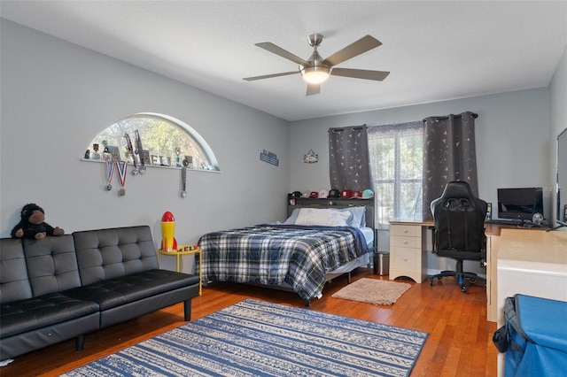 bedroom with wood-type flooring and ceiling fan