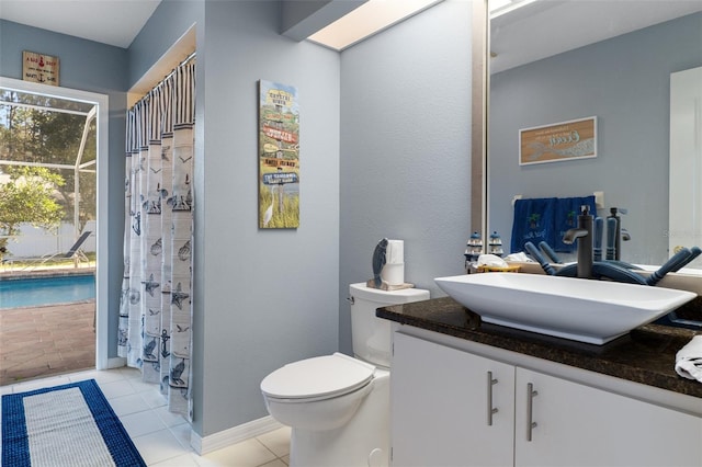 bathroom featuring tile patterned floors, curtained shower, vanity, and toilet