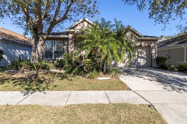 view of front of property featuring a front yard and a garage