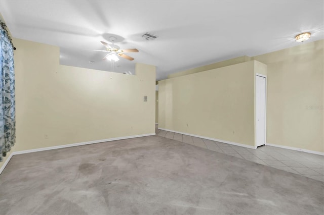 unfurnished room with ceiling fan and light colored carpet