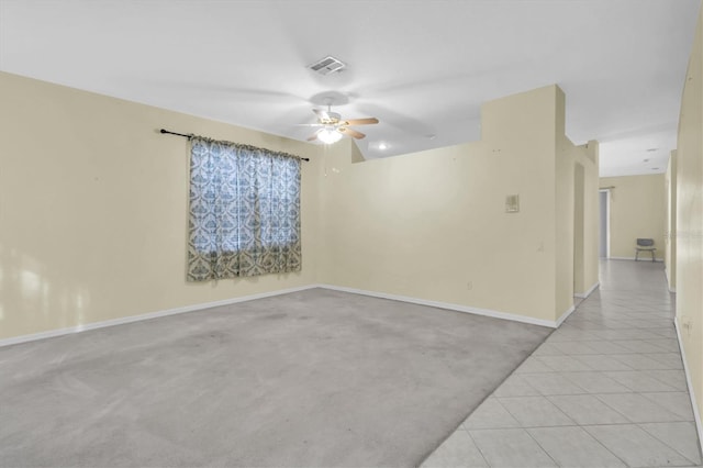 carpeted spare room featuring ceiling fan