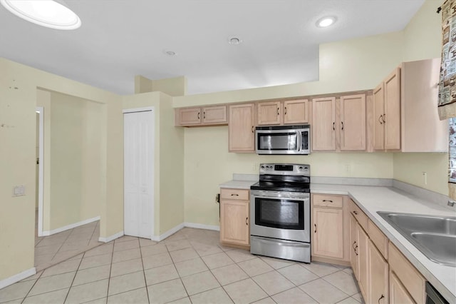 kitchen featuring sink, light brown cabinets, and stainless steel appliances