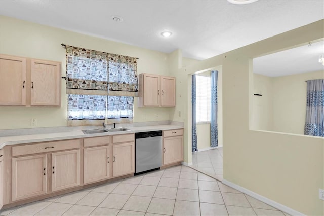 kitchen with light tile patterned flooring, dishwasher, light brown cabinets, and sink