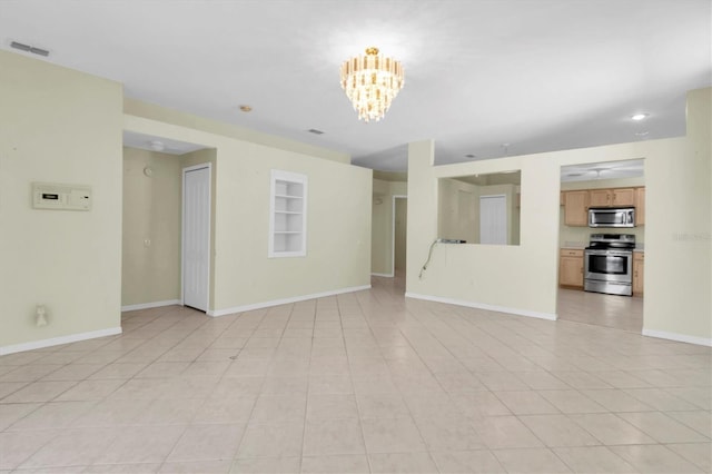 unfurnished living room featuring light tile patterned floors and a notable chandelier