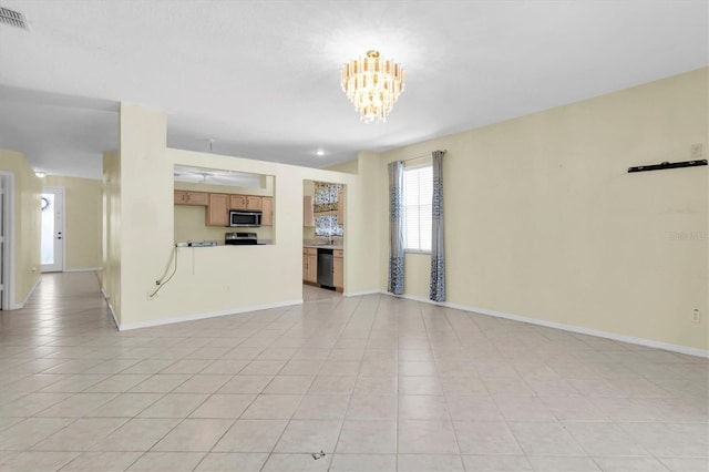 unfurnished living room featuring light tile patterned floors and an inviting chandelier