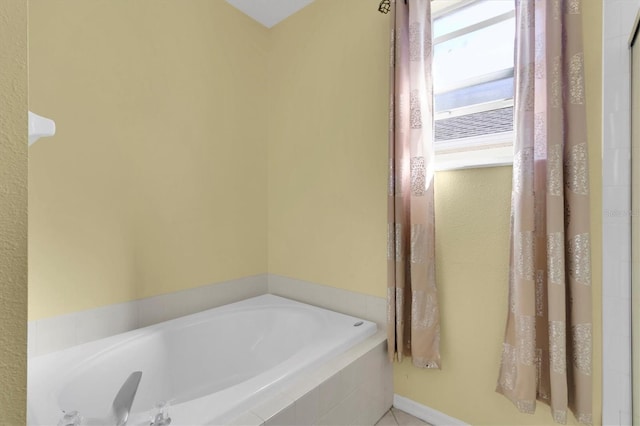 bathroom featuring tiled tub