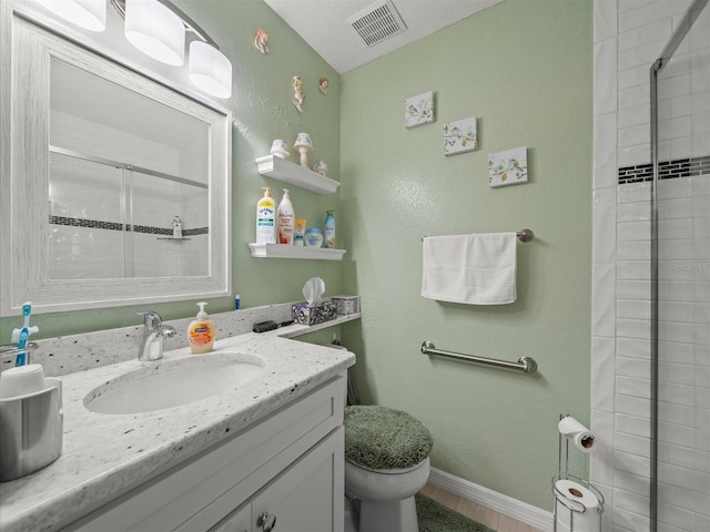 bathroom featuring toilet, a shower with shower door, and vanity