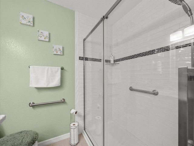 bathroom with a shower with shower door