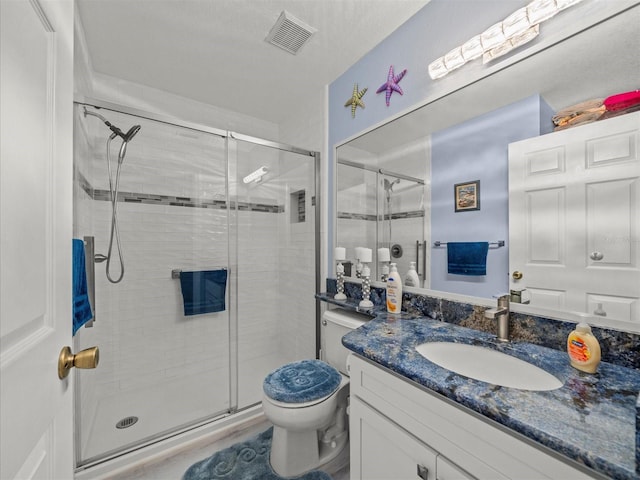 bathroom with toilet, walk in shower, and vanity