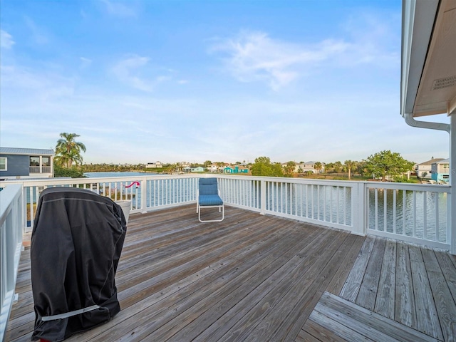 deck featuring area for grilling and a water view