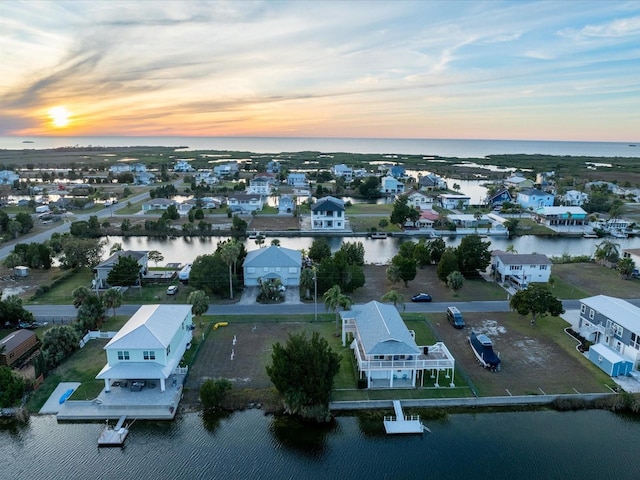 aerial view at dusk with a water view