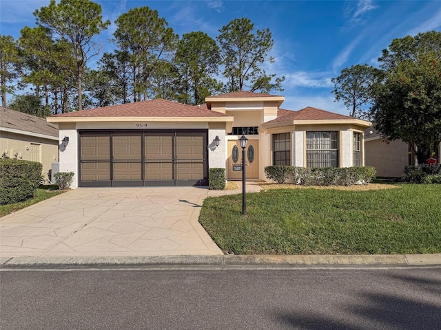 view of front facade with a front yard and a garage