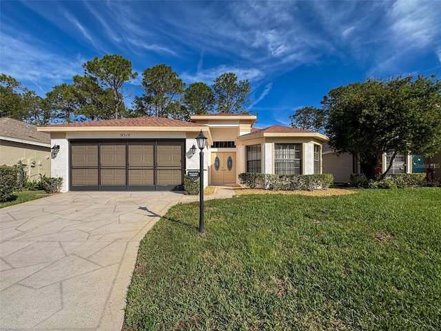 view of front of house with a garage and a front lawn