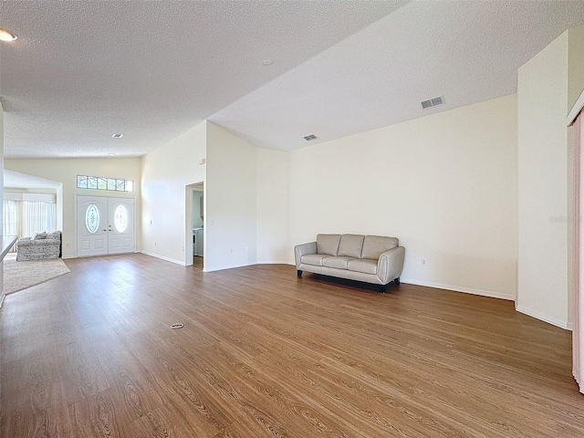 unfurnished room with wood-type flooring and a textured ceiling