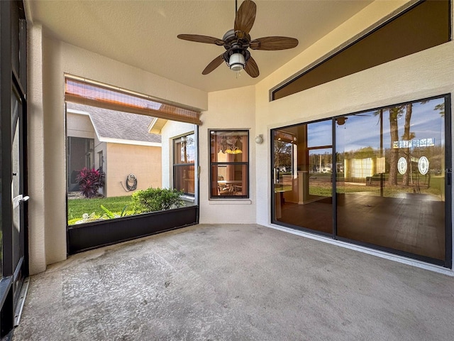 unfurnished sunroom with ceiling fan and lofted ceiling