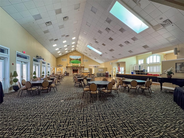 carpeted dining space with a high ceiling