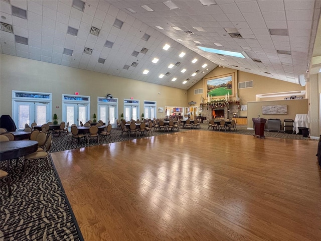 gym with a towering ceiling and hardwood / wood-style flooring