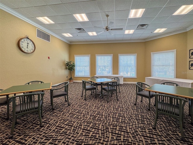 dining area with ceiling fan, carpet floors, and crown molding