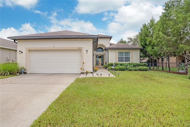 view of front of home with a garage and a front yard