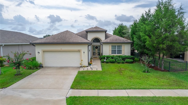 view of front of home with a front yard and a garage