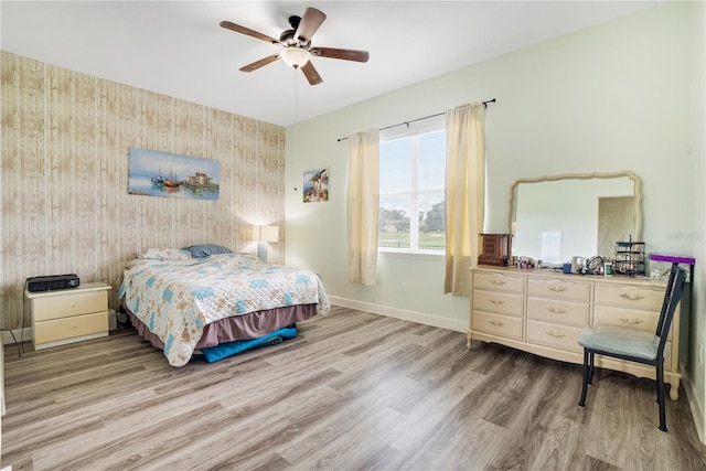 bedroom with ceiling fan and hardwood / wood-style floors