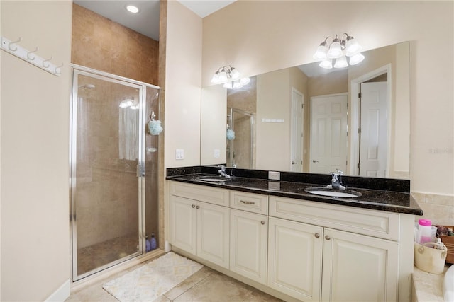 bathroom featuring tile patterned floors, vanity, a chandelier, and walk in shower