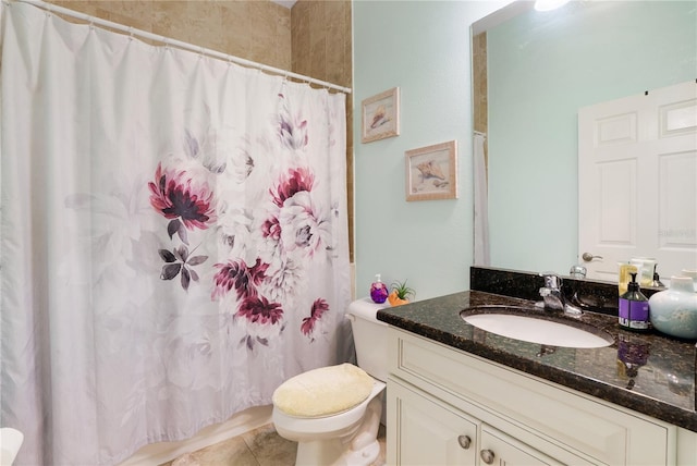 bathroom featuring tile patterned floors, vanity, curtained shower, and toilet