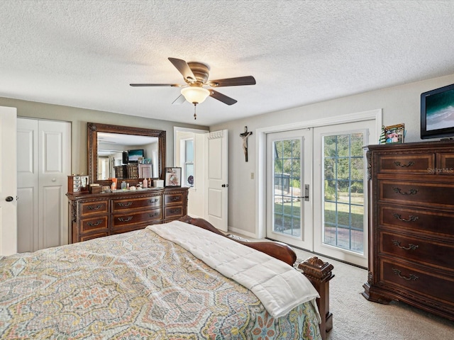 carpeted bedroom featuring ceiling fan, french doors, a textured ceiling, access to outside, and a closet