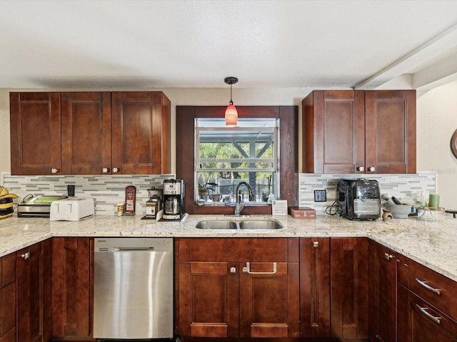 kitchen with light stone countertops, decorative backsplash, stainless steel dishwasher, sink, and decorative light fixtures