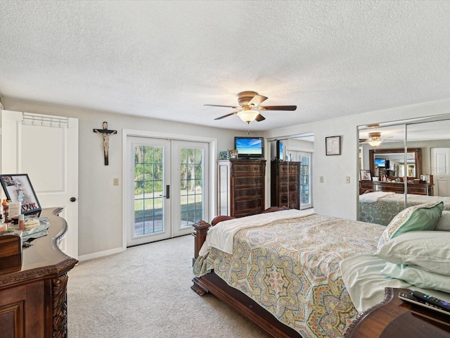 carpeted bedroom featuring ceiling fan, a textured ceiling, access to outside, and french doors